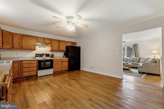 kitchen featuring brown cabinetry, electric range oven, black fridge with ice dispenser, open floor plan, and light countertops