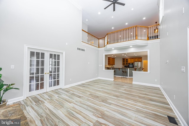 2729 Hollow View Dr, Finksburg, MD 21048 - unfurnished living room with ceiling fan, french doors, a towering ceiling, light wood finished floors, and recessed lighting