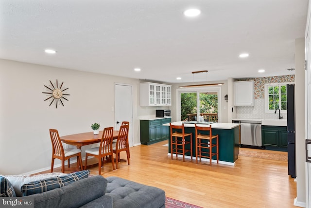 interior space featuring light wood finished floors, baseboards, and recessed lighting