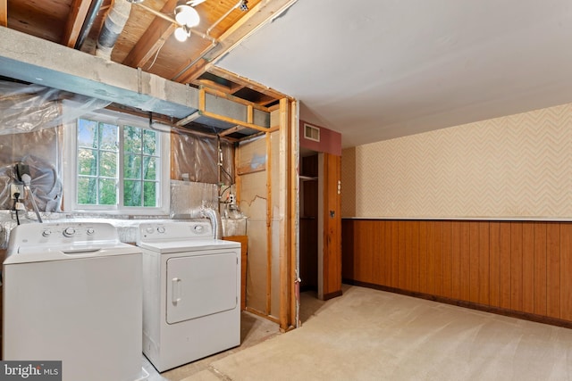 laundry room featuring washing machine and dryer, visible vents, wallpapered walls, and laundry area