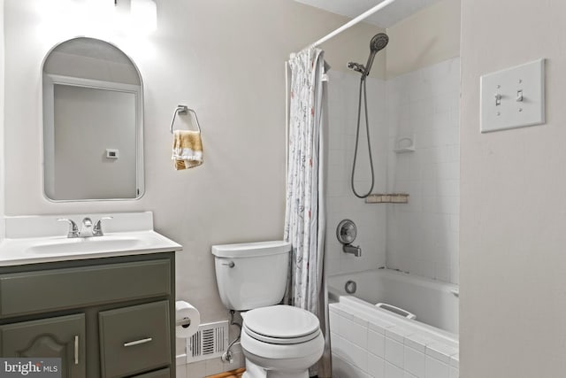 bathroom with visible vents, toilet, vanity, and shower / bath combo with shower curtain
