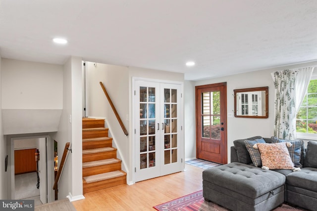 living room with french doors, wood finished floors, recessed lighting, and stairs