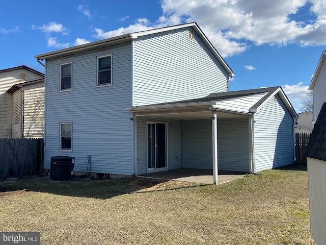 back of property with cooling unit, fence, a lawn, and a patio