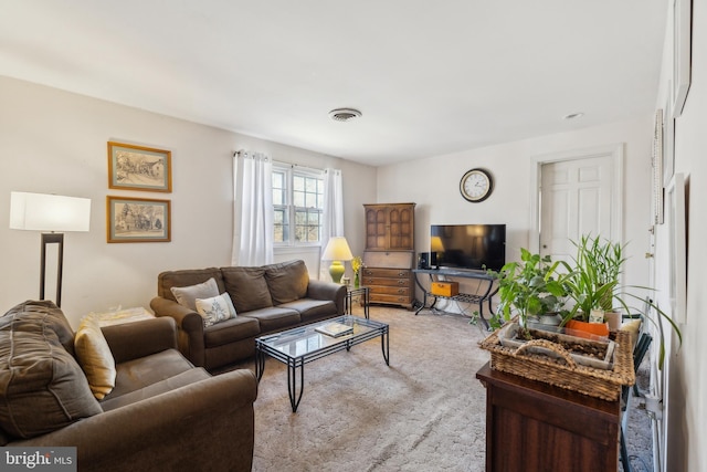 living room featuring carpet floors and visible vents