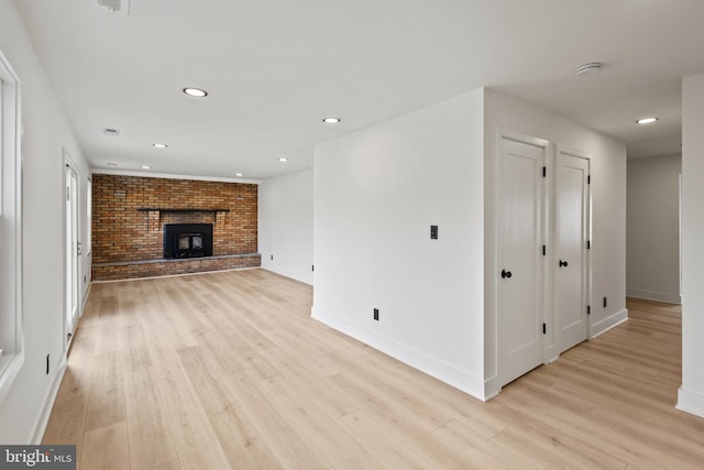 unfurnished living room with recessed lighting, baseboards, and light wood-style floors