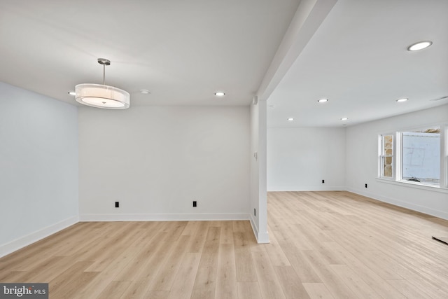 empty room with recessed lighting, light wood-style floors, and baseboards