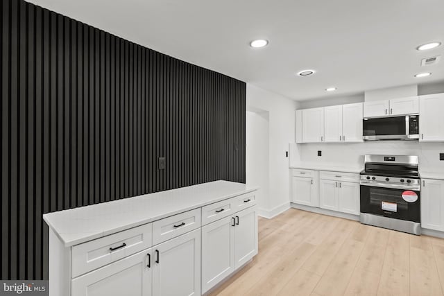 kitchen featuring visible vents, white cabinetry, recessed lighting, appliances with stainless steel finishes, and light wood finished floors