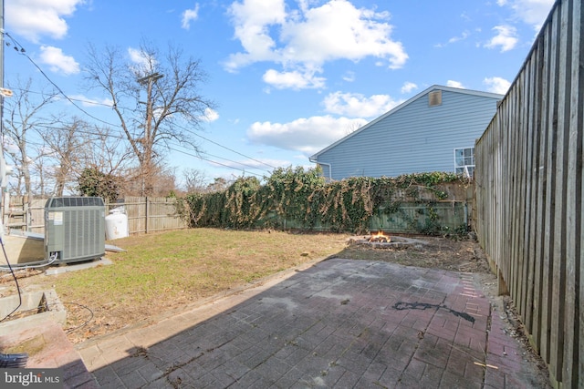 view of yard with central AC, a patio, and a fenced backyard