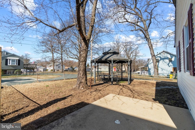 view of yard featuring a patio area, a residential view, and a gazebo