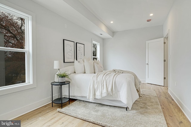 bedroom with light wood-style floors, recessed lighting, and baseboards