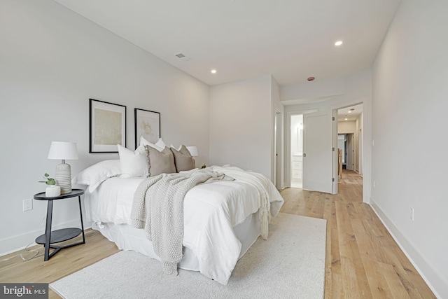 bedroom with light wood-type flooring, visible vents, baseboards, and recessed lighting