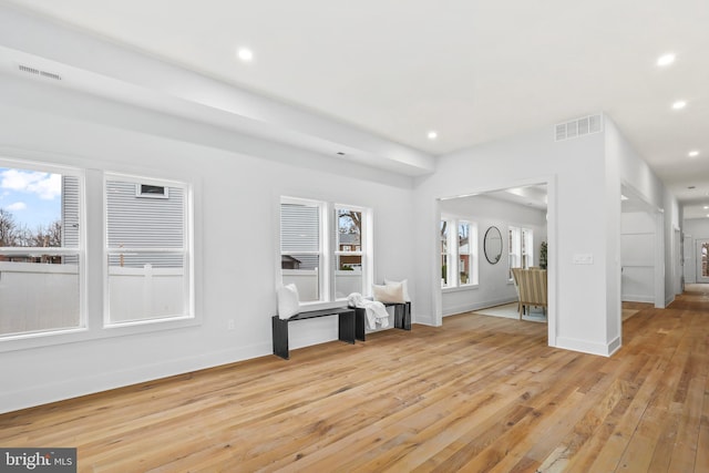 unfurnished living room with recessed lighting, baseboards, visible vents, and light wood finished floors