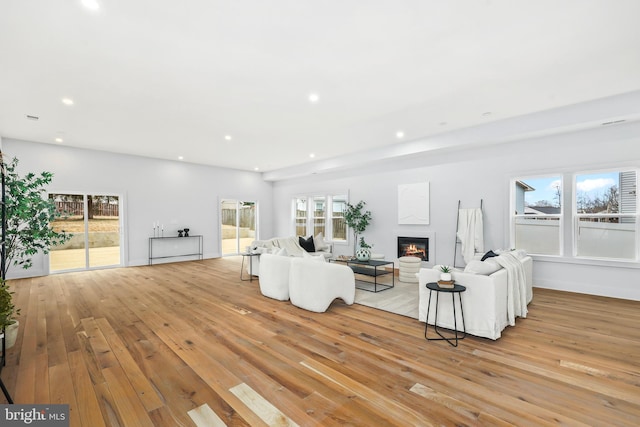 unfurnished living room featuring plenty of natural light, light wood-type flooring, and recessed lighting