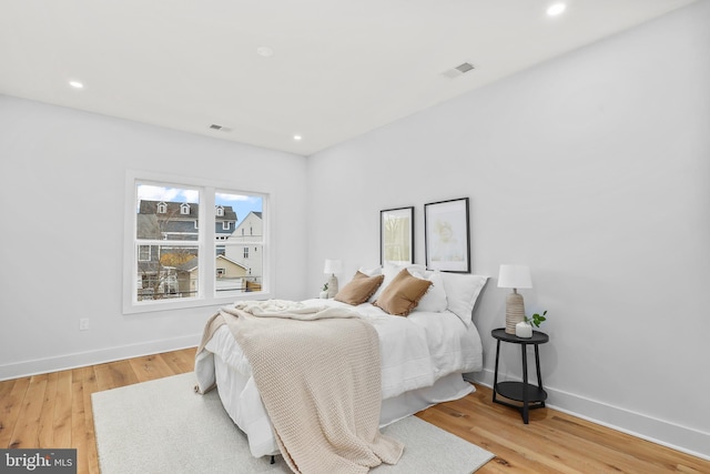 bedroom featuring recessed lighting, wood finished floors, visible vents, and baseboards