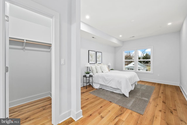 bedroom featuring hardwood / wood-style floors, recessed lighting, and baseboards