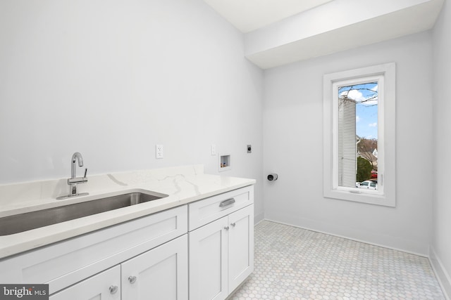 laundry area featuring washer hookup, a sink, baseboards, cabinet space, and electric dryer hookup