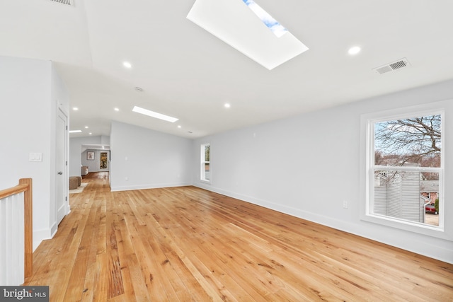 unfurnished living room featuring light wood-style flooring, visible vents, baseboards, and recessed lighting