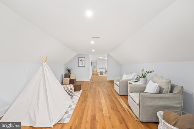 interior space featuring vaulted ceiling, visible vents, light wood-style flooring, and recessed lighting