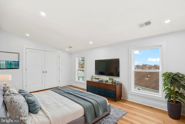 bedroom featuring recessed lighting, visible vents, vaulted ceiling, and light wood finished floors