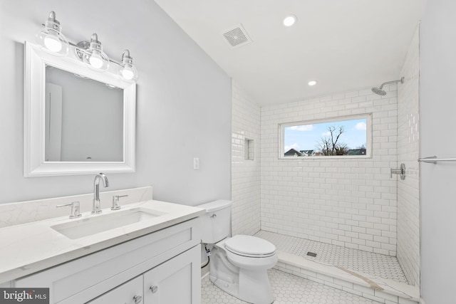 full bathroom featuring visible vents, toilet, a stall shower, vanity, and tile patterned flooring