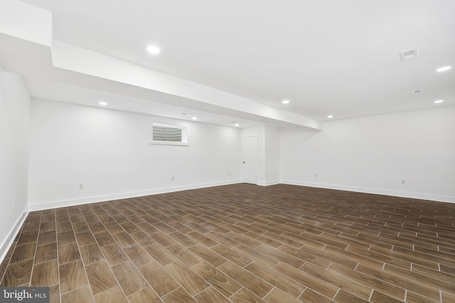 finished below grade area with recessed lighting, visible vents, baseboards, and wood finished floors