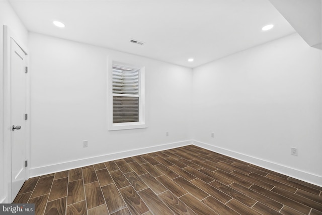 spare room featuring wood finish floors, visible vents, baseboards, and recessed lighting