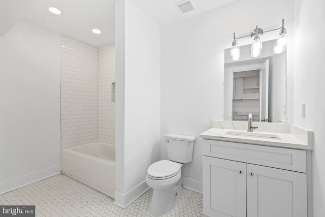 bathroom featuring toilet, vanity, visible vents, and baseboards