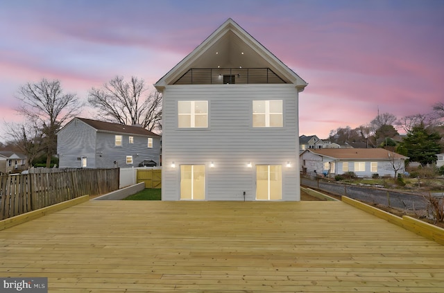 back of property featuring fence and a wooden deck