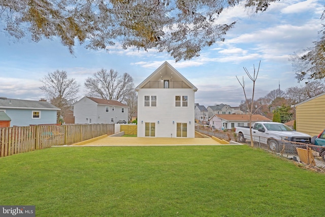 back of property with a patio, a lawn, a fenced backyard, and a residential view