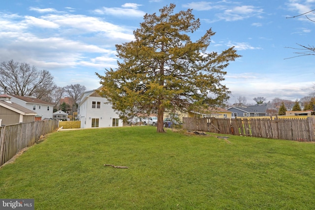 view of yard with a fenced backyard and a residential view