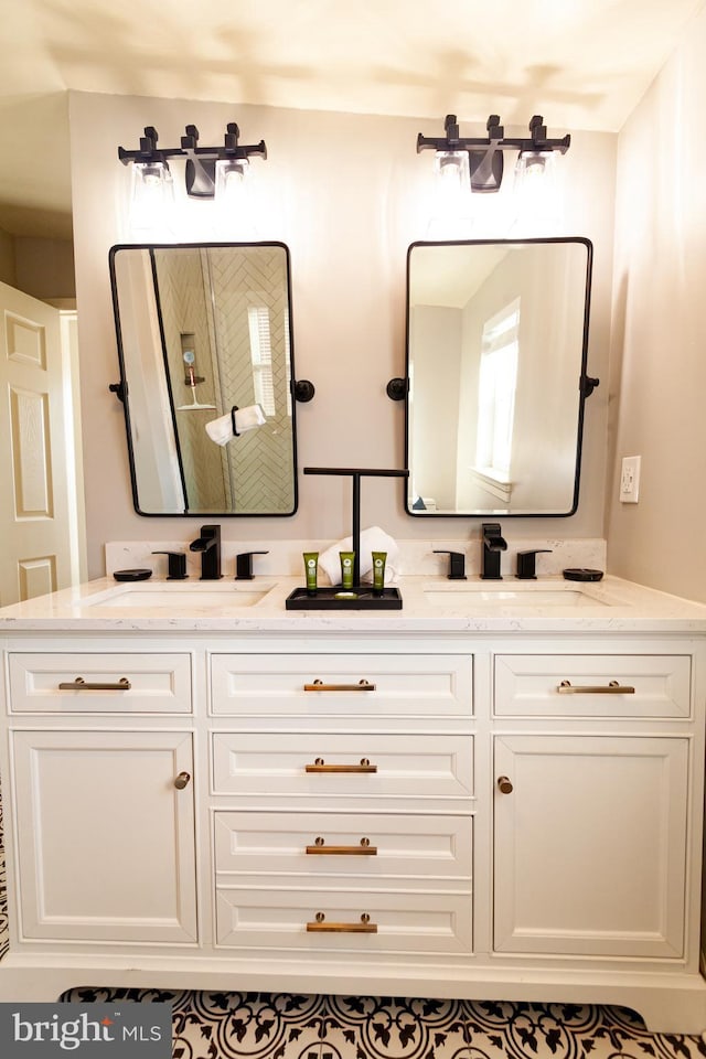 bathroom with a sink and double vanity