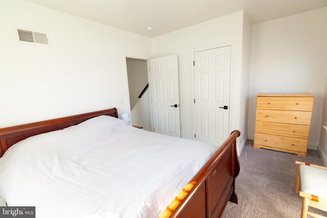 bedroom featuring baseboards, visible vents, and carpet flooring