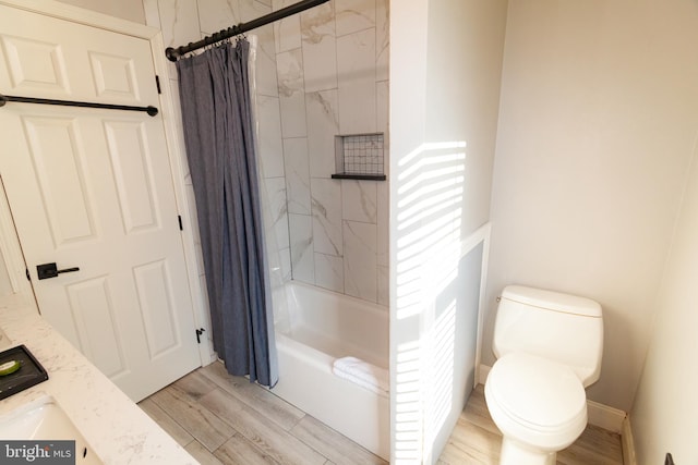 full bath with shower / bath combo with shower curtain, wood finished floors, and toilet