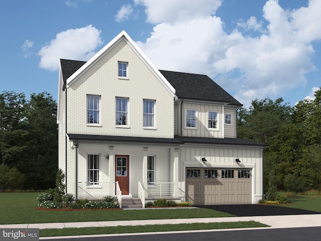 view of front of house with aphalt driveway, a garage, brick siding, a front lawn, and board and batten siding