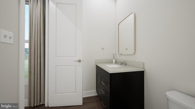 bathroom featuring vanity, toilet, and wood finished floors