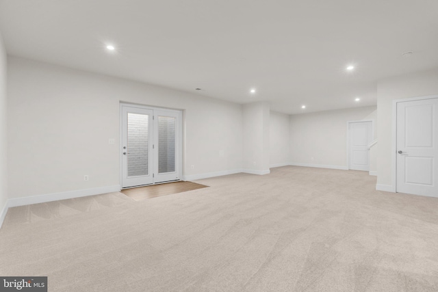 empty room featuring light colored carpet and recessed lighting