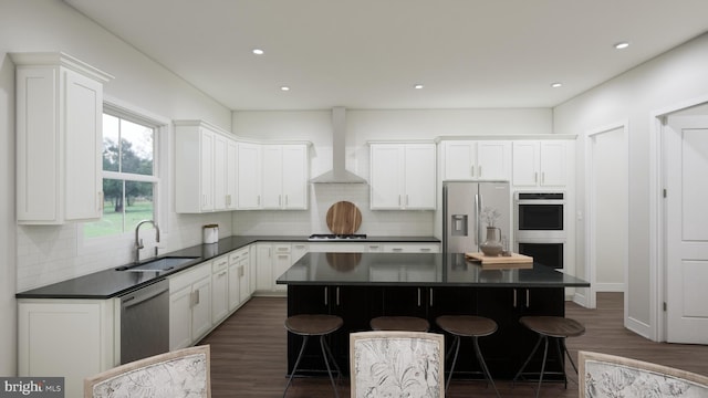 kitchen with dark countertops, a kitchen island, appliances with stainless steel finishes, and a sink