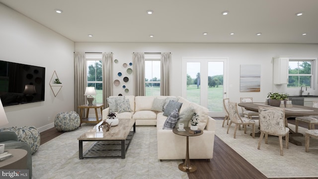 living area featuring baseboards, recessed lighting, and wood finished floors