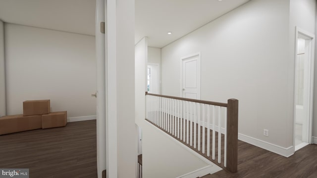 hall with recessed lighting, baseboards, an upstairs landing, and wood finished floors