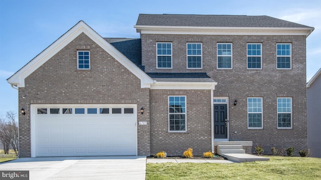 view of front of home featuring a garage, a shingled roof, concrete driveway, a front lawn, and brick siding