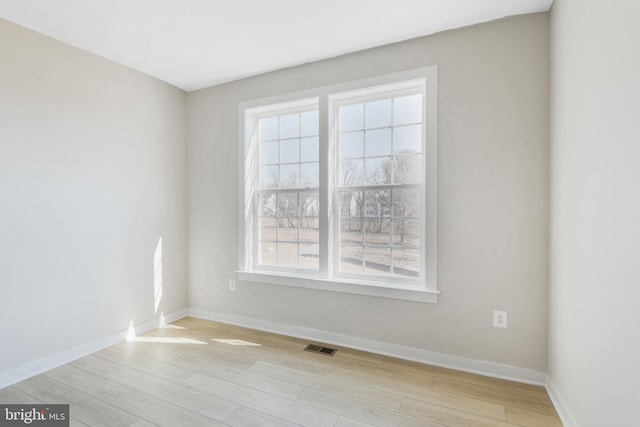 spare room with light wood-style flooring and baseboards