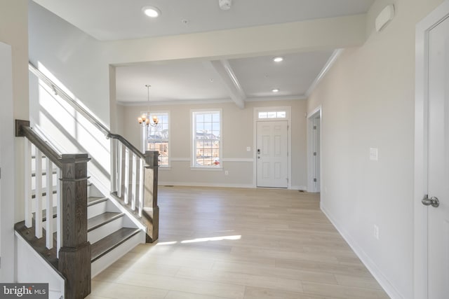 entryway featuring recessed lighting, baseboards, ornamental molding, stairway, and light wood finished floors