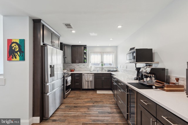 kitchen featuring a sink, visible vents, light countertops, appliances with stainless steel finishes, and tasteful backsplash