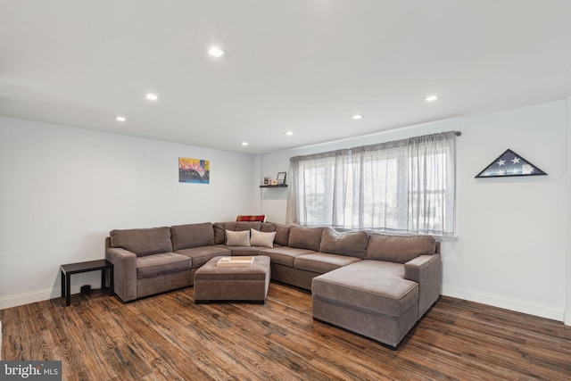 living room featuring recessed lighting, dark wood finished floors, and baseboards