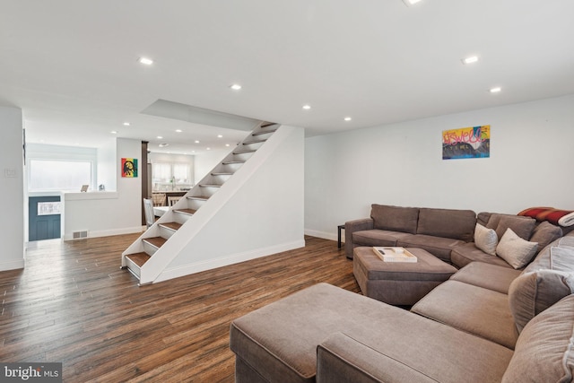 living room with stairs, visible vents, wood finished floors, and recessed lighting