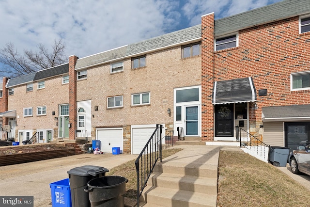 view of property featuring driveway and an attached garage