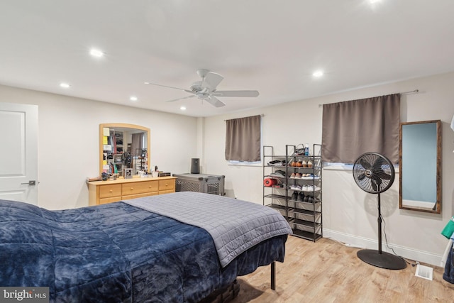 bedroom featuring baseboards, light wood-type flooring, a ceiling fan, and recessed lighting