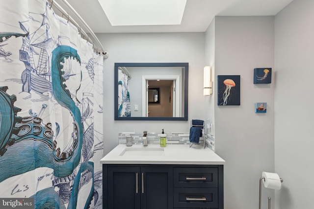 full bathroom featuring tasteful backsplash, a skylight, and vanity