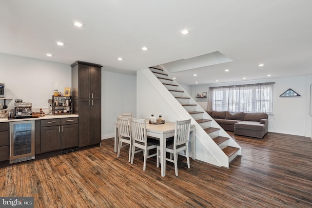 interior space with wine cooler, stairway, dark wood finished floors, and recessed lighting