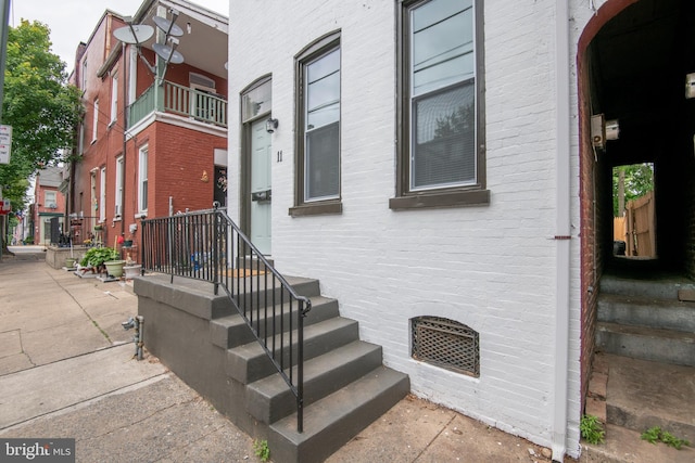 property entrance featuring brick siding